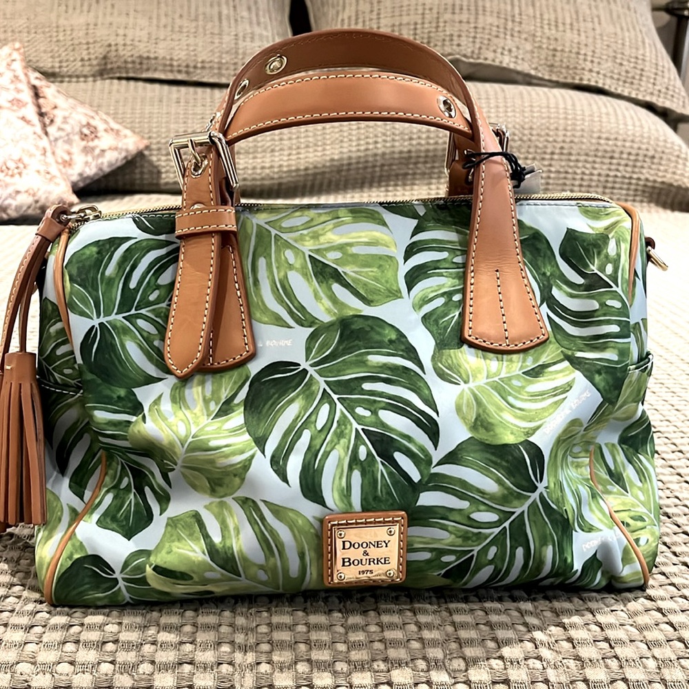 Dooney & Butke. Brand new. Includes crossbody strap.